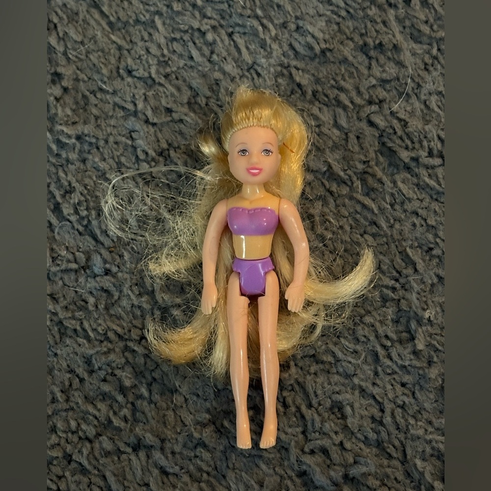 Lightly used Polly Pocket with long blonde hair and purple undergarments